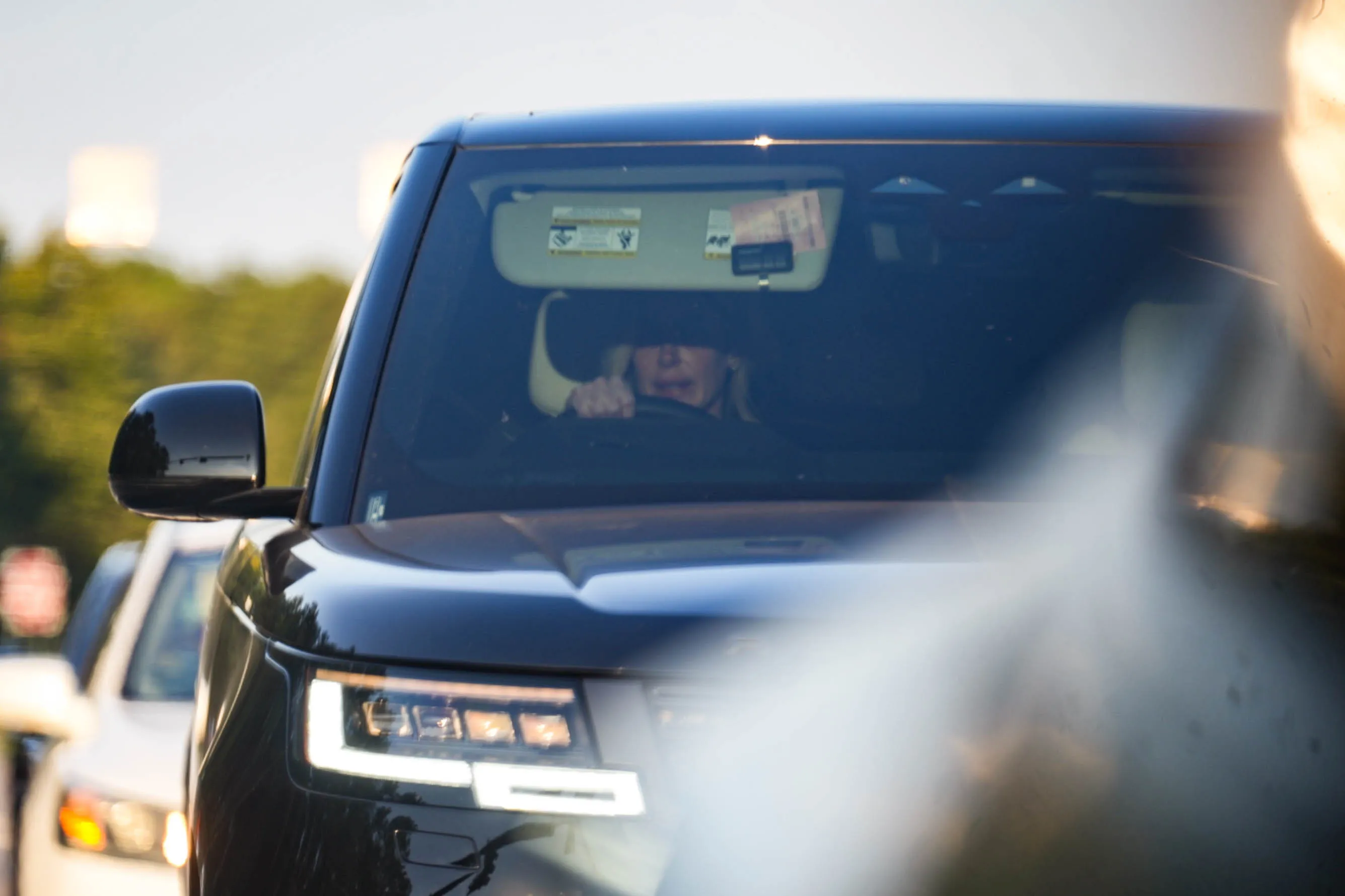 Kim Zolciak driving a black SUV.