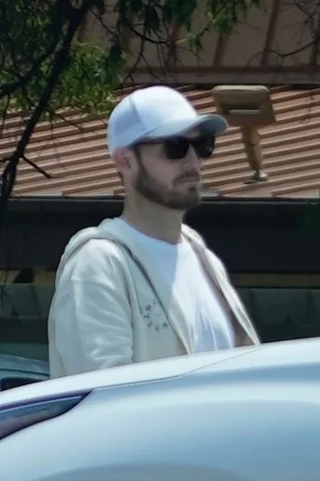 Brian Hickerson wearing a white cap and sunglasses.