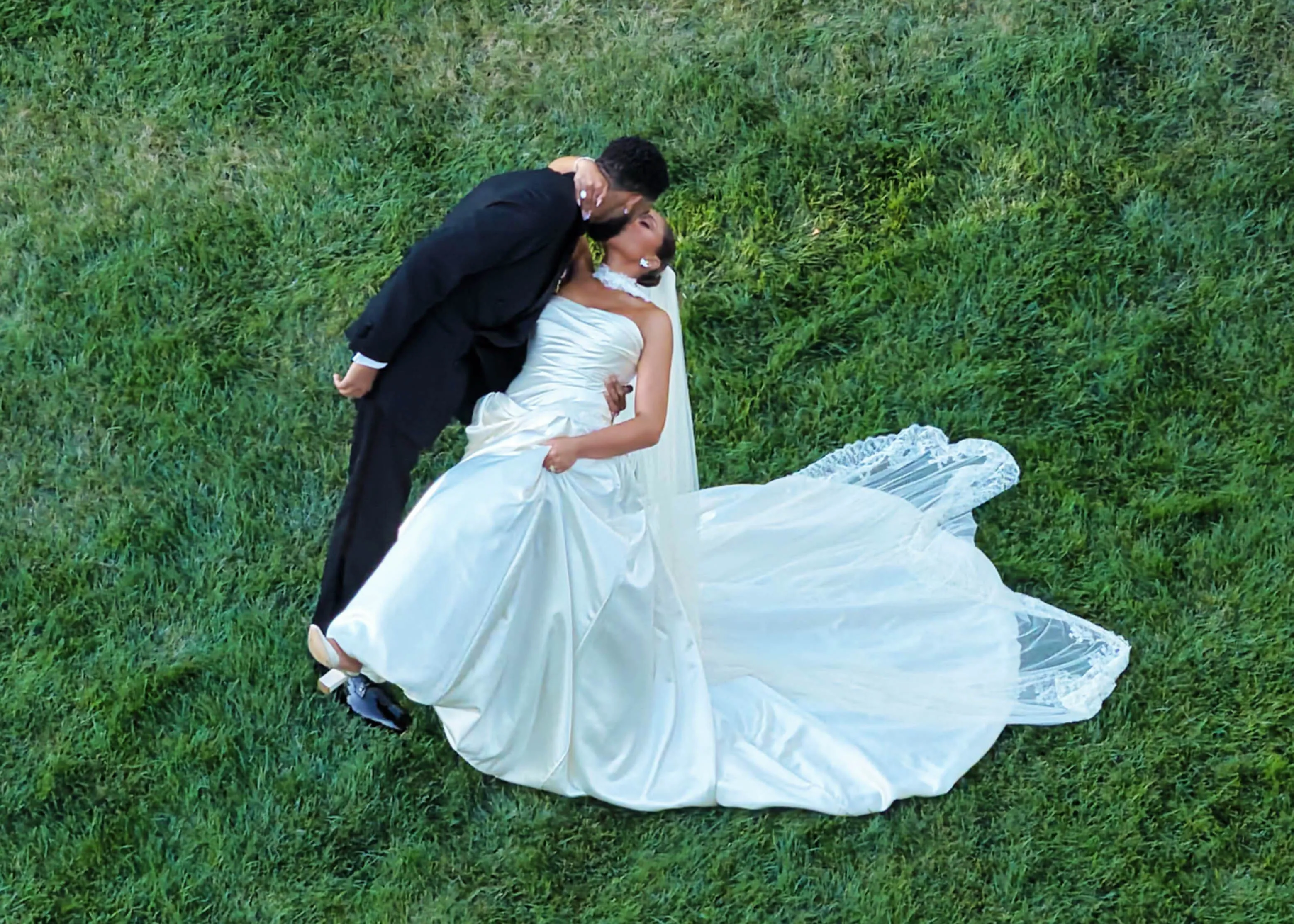 Jordyn Woods and Karl-Anthony Towns kissing on their wedding day.