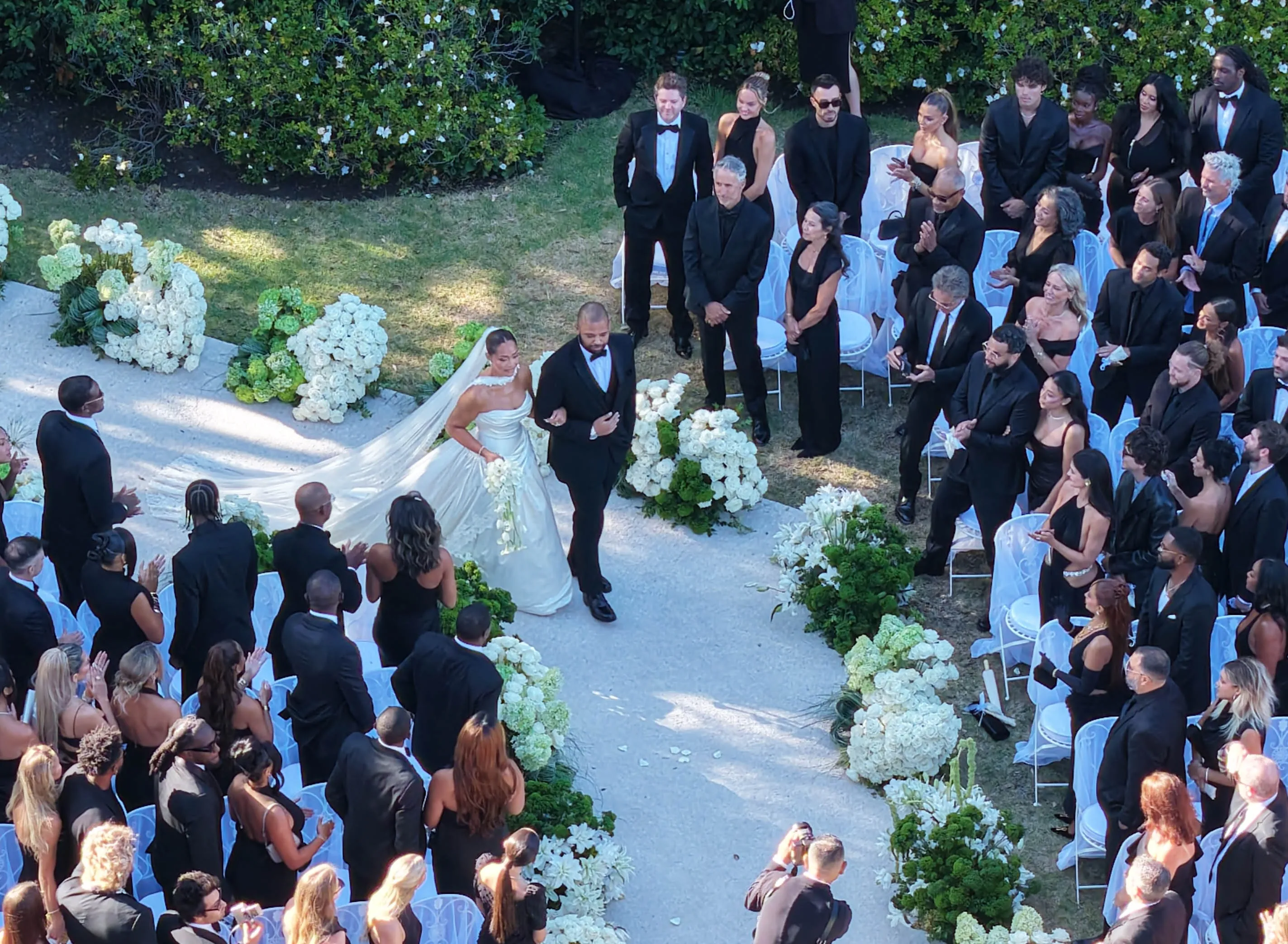 Jordyn Woods and Karl-Anthony Towns walking down the aisle at their wedding.