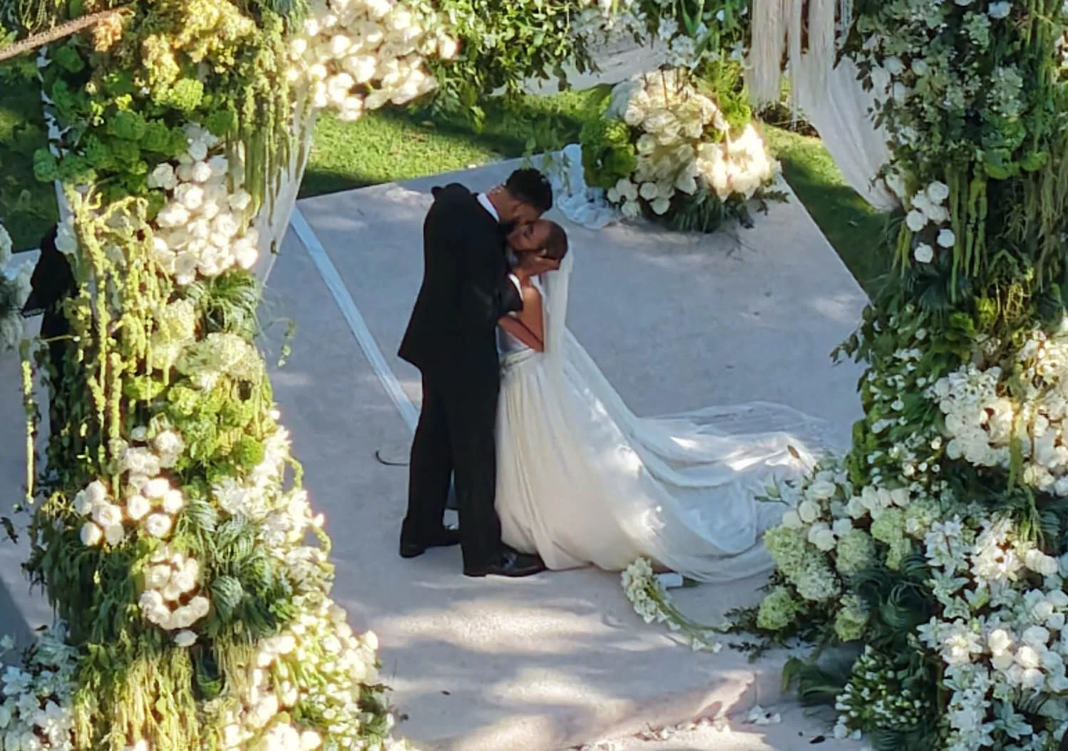 Jordyn Woods and Karl-Anthony Towns kissing at their wedding.