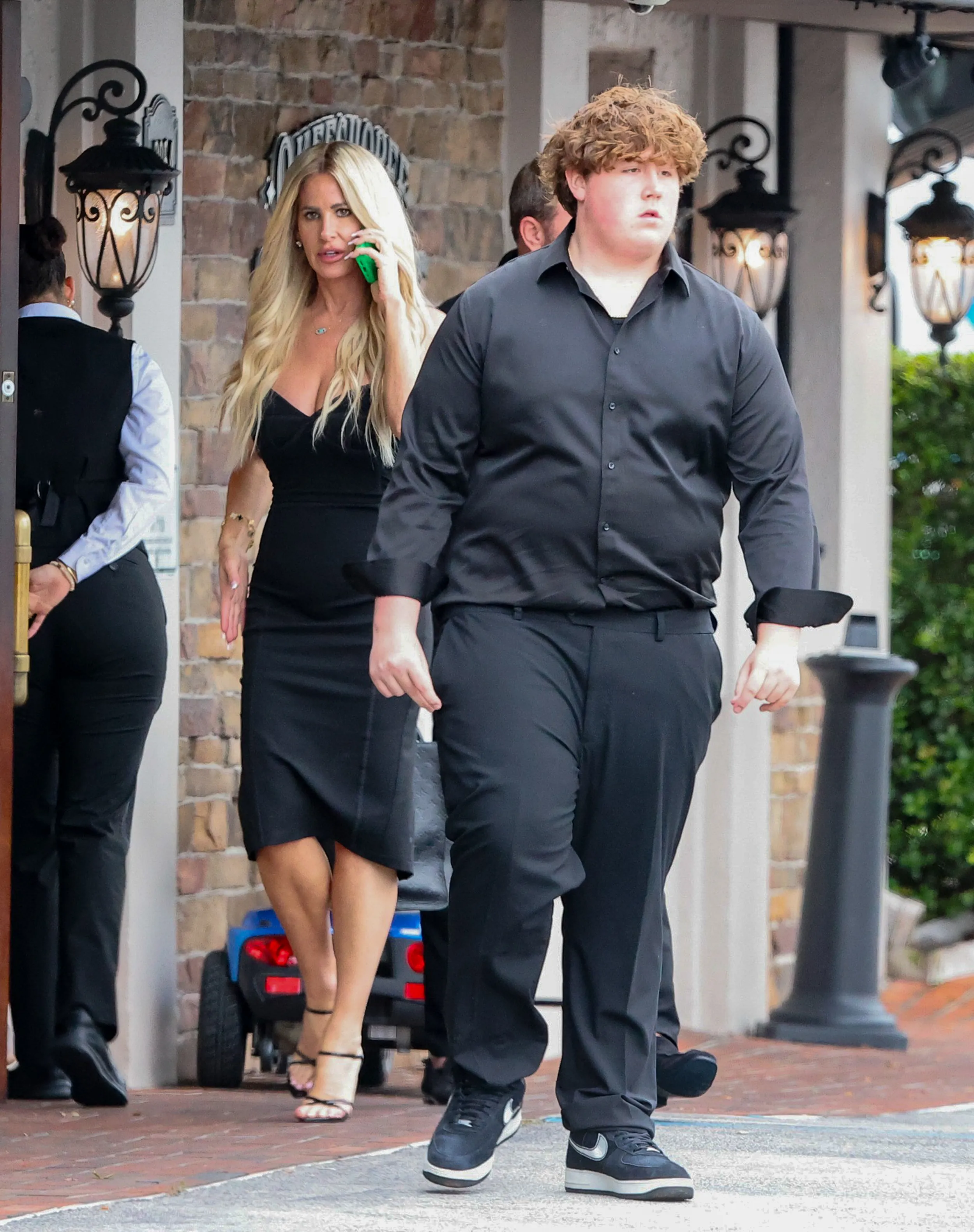 Kim Zolciak walking with her son Kash and boyfriend Kyle Mowitz in Palm Beach.