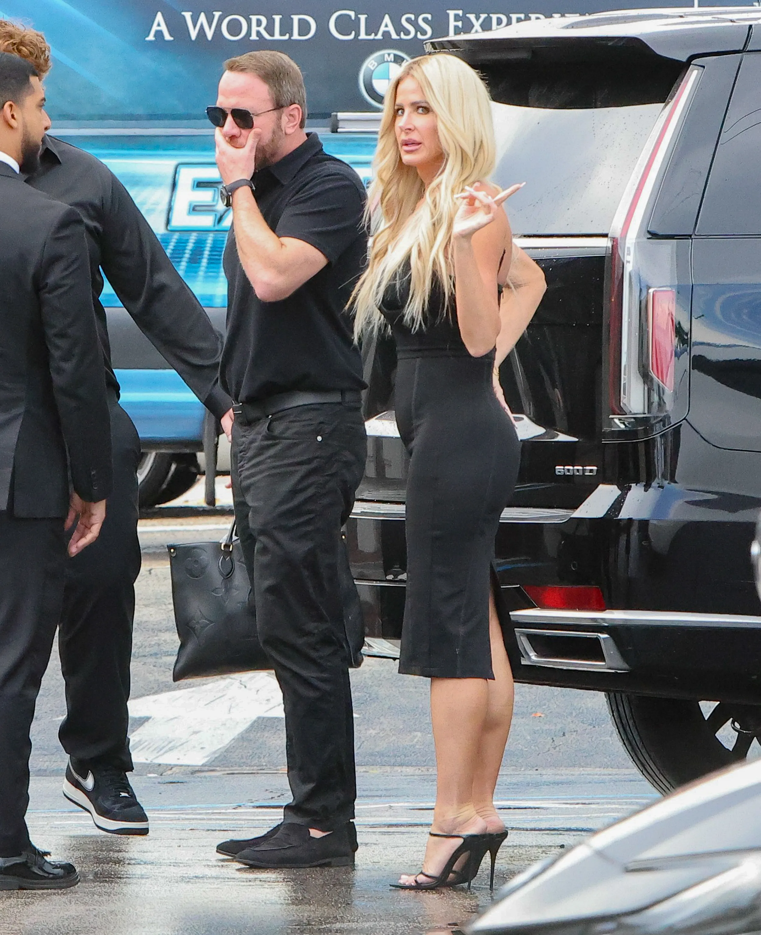 Kim Zolciak in a black dress on a dinner outing with Kyle Mowitz and her son Kash in Palm Beach.