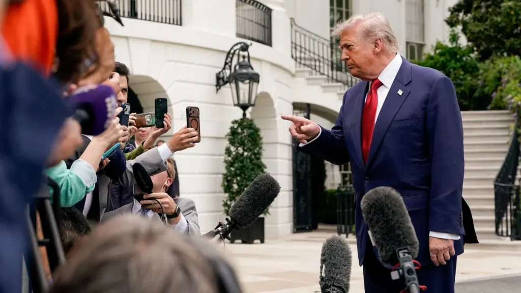 Trump fondles tree photos in front of baffled reporter: ‘There is no precedent’