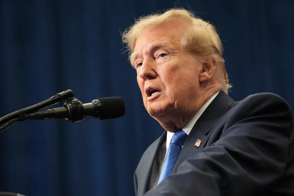 Donald Trump speaking into a microphone.