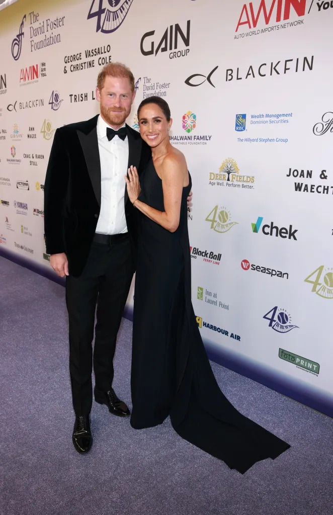 Prince Harry and Meghan Markle pose together in formal wear at the David Foster Foundation 40th Anniversary Celebration.