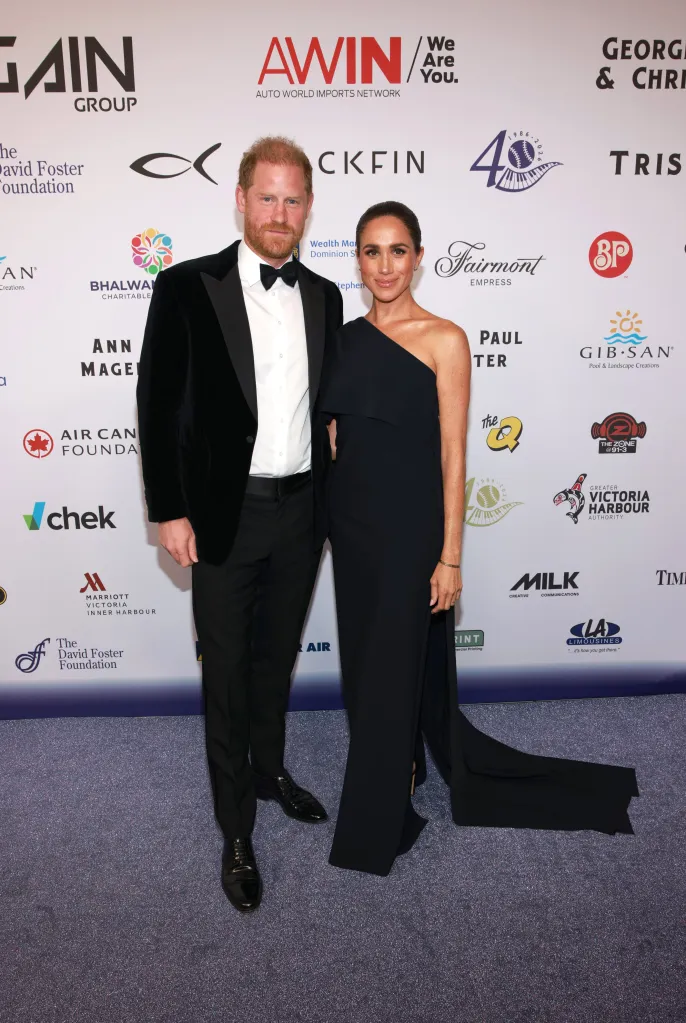 Prince Harry, in a black tuxedo, and Meghan, Duchess of Sussex, in a one-shoulder black gown, attend the David Foster Foundation 40th Anniversary Celebration.