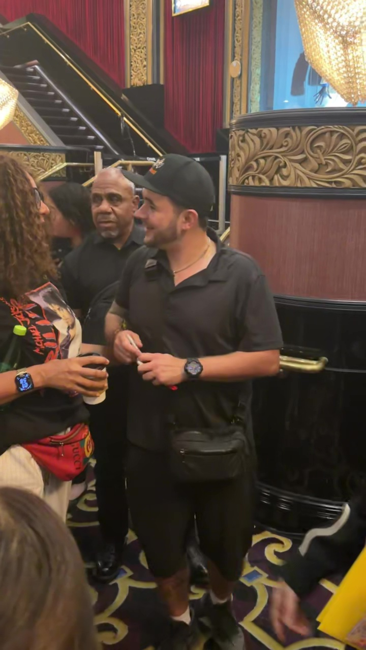 Prince Jackson wearing a black shirt and shorts, making a public appearance.