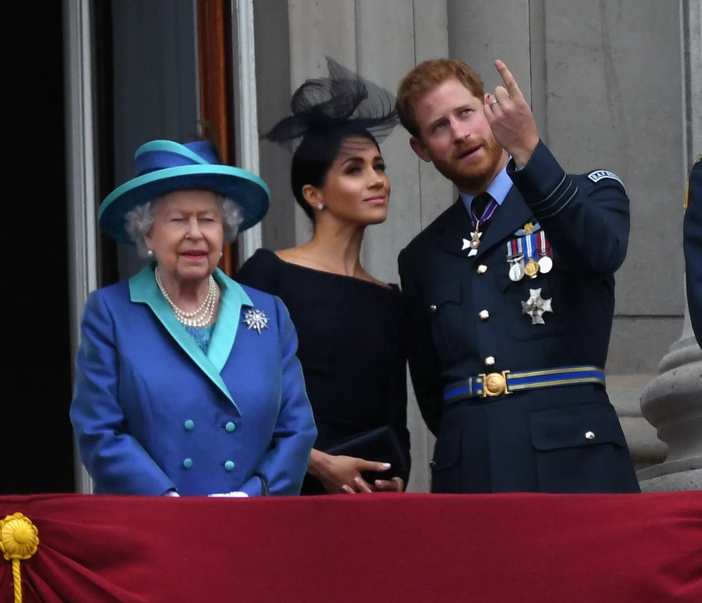 Queen Elizabeth, Meghan Markle, and Prince Harry.
