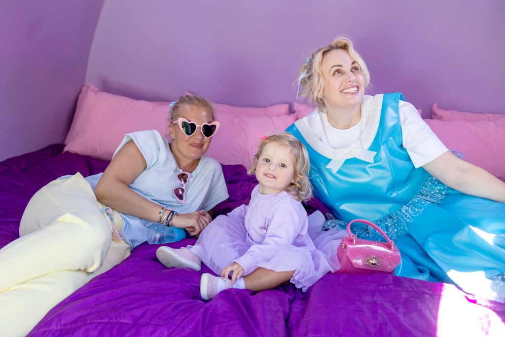Rebel Wilson and Ramona Agruma pose with their daughter Royce Lillian Wilson at Polly Pocket's Airbnb.