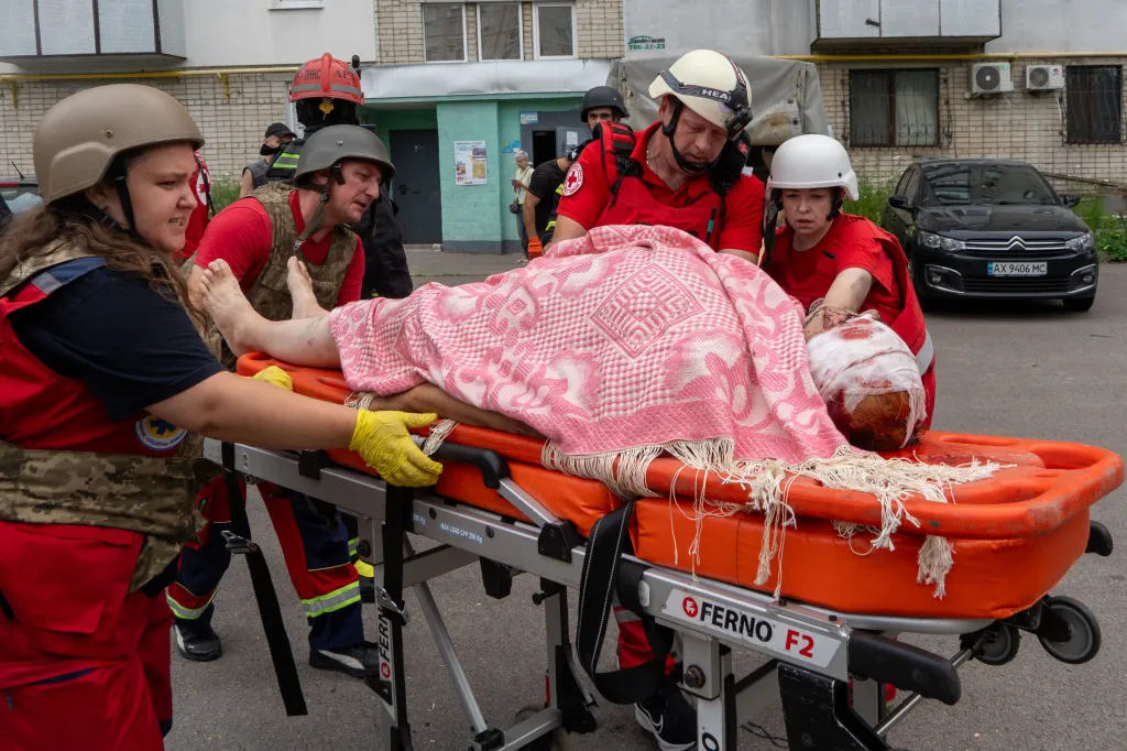 Rescuers evacuate an injured civilian on a stretcher after a drone attack in Kharkiv, Ukraine.