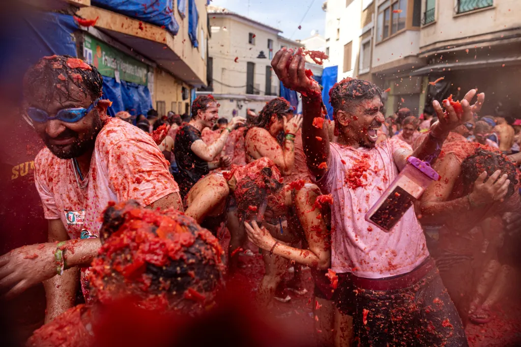 Revelers throwing tomatoes during the La Tomatina food fight festival in Buñol, Spain.