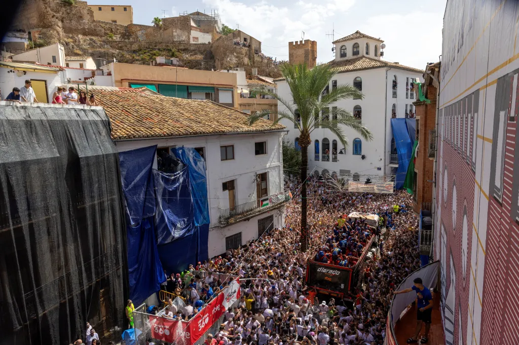 Crowds of people participate in the La Tomatina food fight festival in Bunol, Spain.