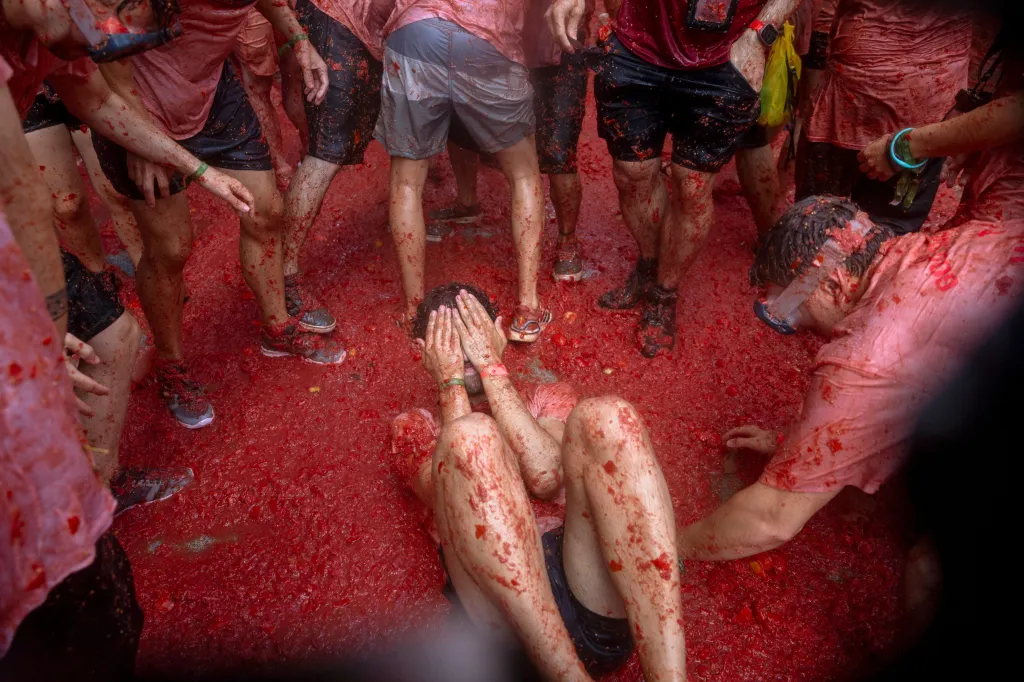 People covered in tomato pulp at the La Tomatina festival in Buñol, Spain.
