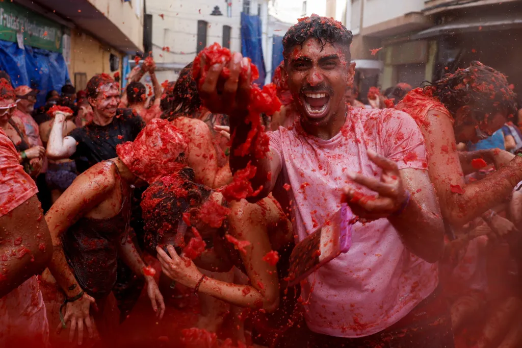 Revellers playing in tomato pulp during the La Tomatina food fight festival in Bunol, Spain.