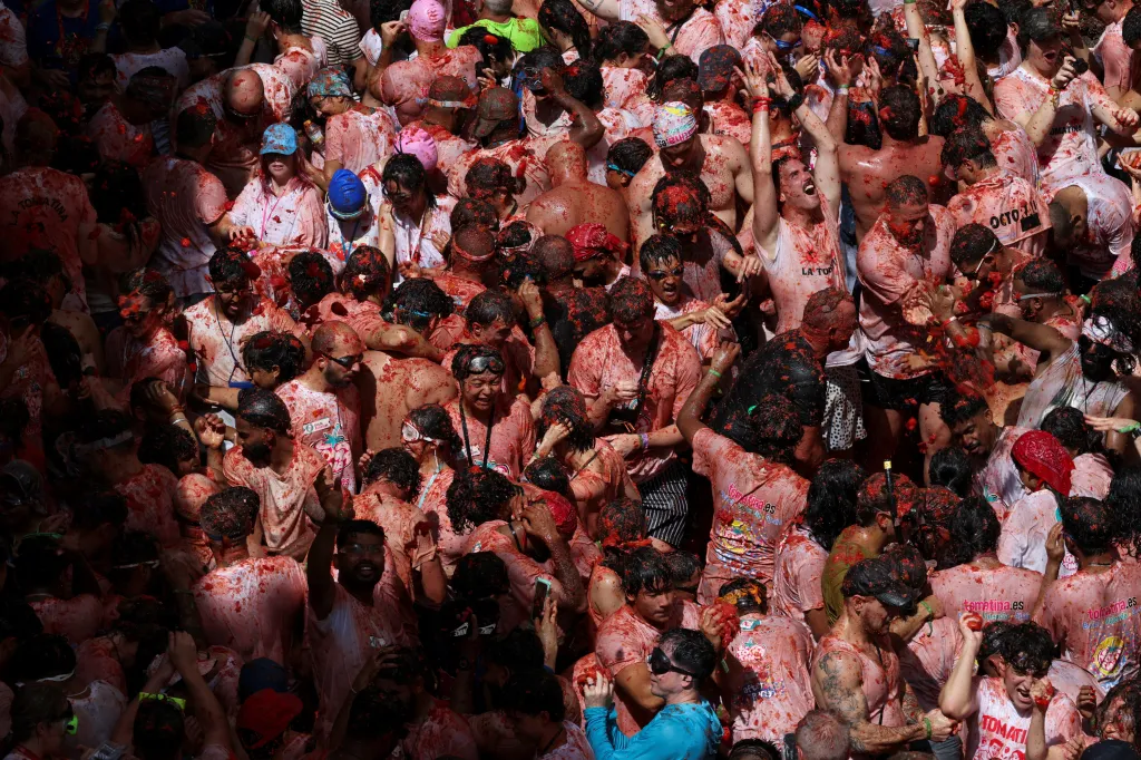 Revellers covered in tomato pulp during the La Tomatina food fight festival in Buñol, Spain.