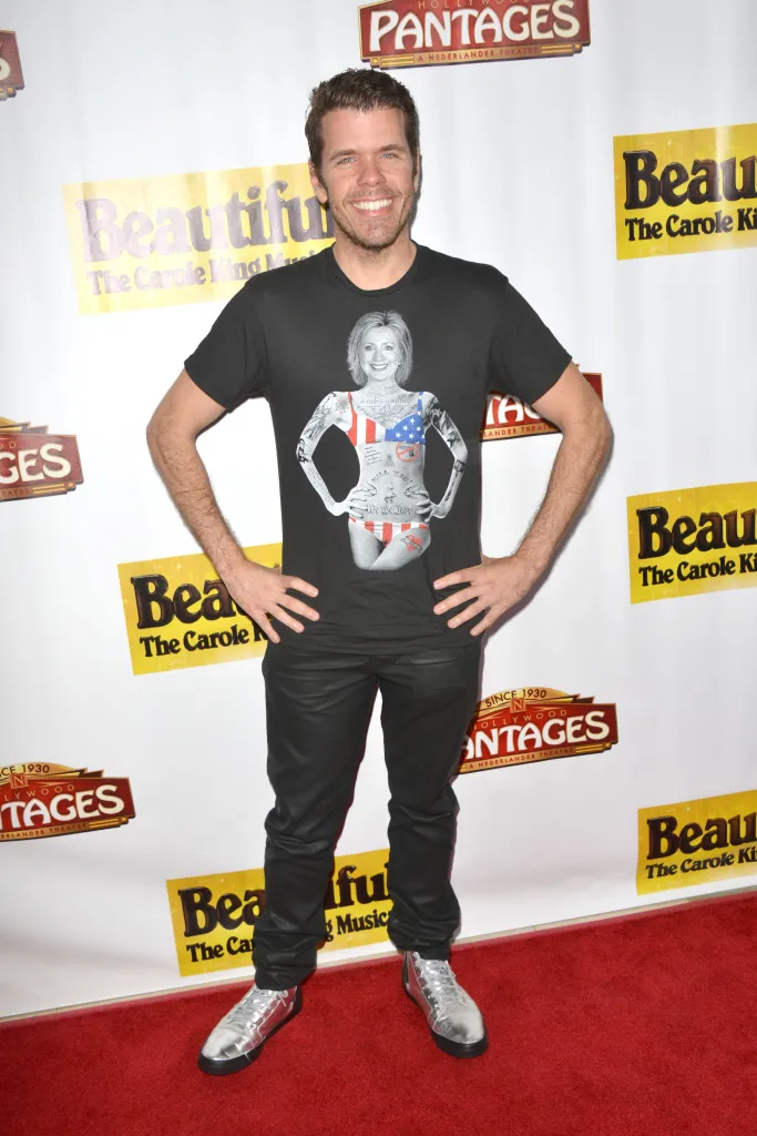 Perez Hilton smiling at the opening night of 
