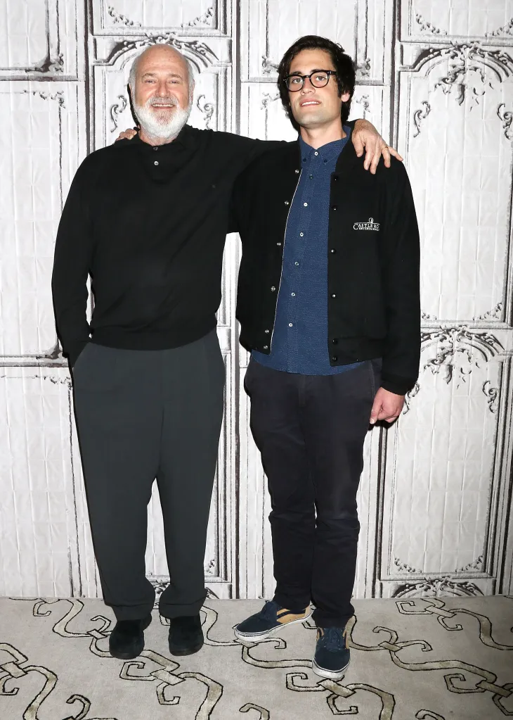 Rob Reiner and Nick Reiner stand side-by-side, Rob with his arm around Nick's shoulders.