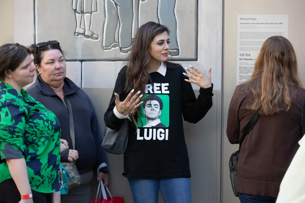 People outside 100 Centre St. for the Luigi Mangione trial, one wearing a 