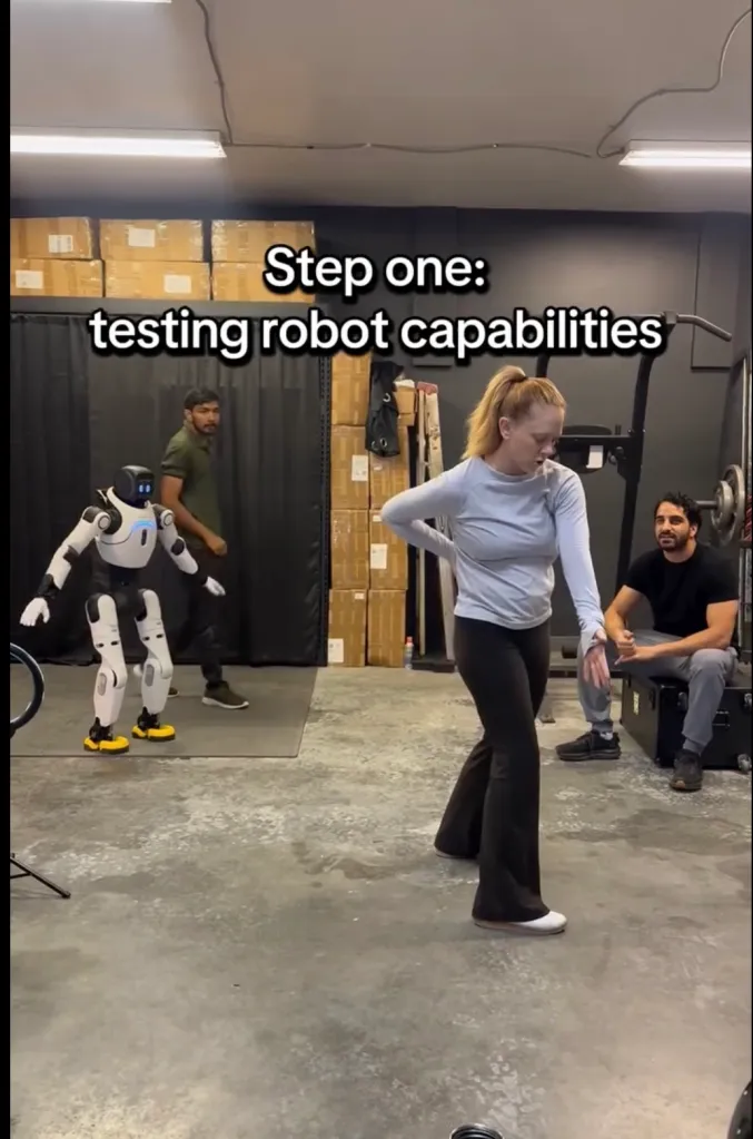 A trainer showing a robot how to act human