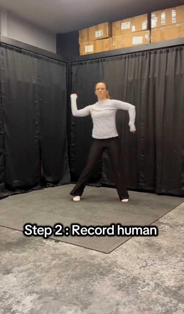 A human trainer at The Robot Studio shows a robot how to move like a person