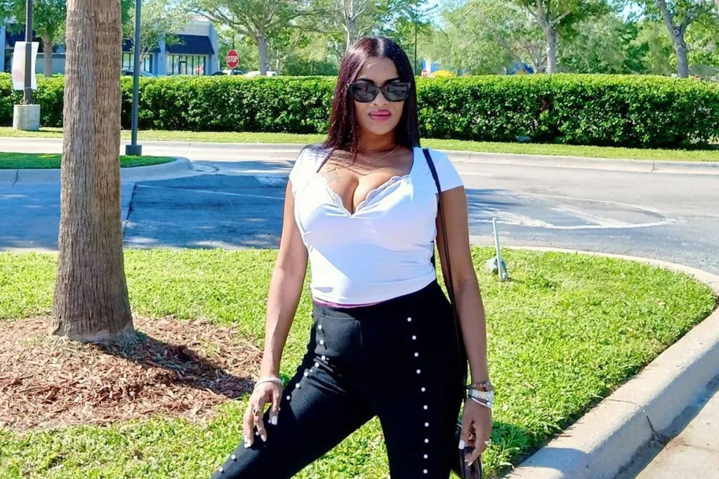 Rosana Kissoon, 39, stands outdoors in a white top, black pants, and sunglasses.