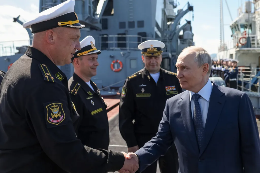 Russian President Vladimir Putin shakes hands with naval officers during his departured from the Varyag missile cruiser of the Pacific Fleet on Sakhalin Island, Russia.