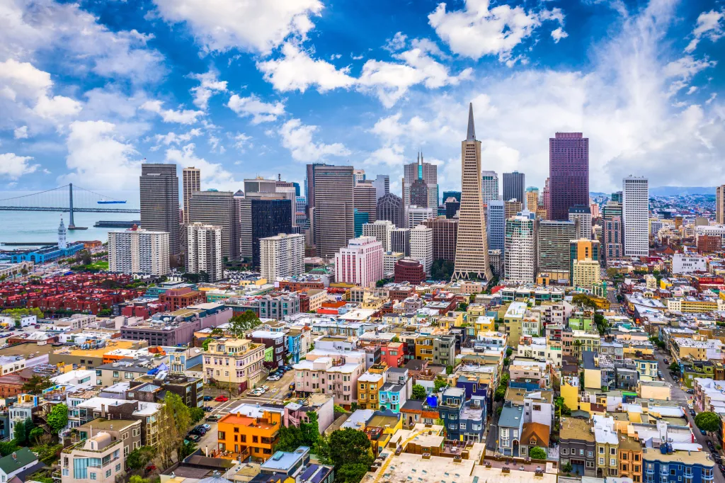Aerial view of the San Francisco, California skyline, with the Transamerica Pyramid in the center and residential buildings in the foreground.