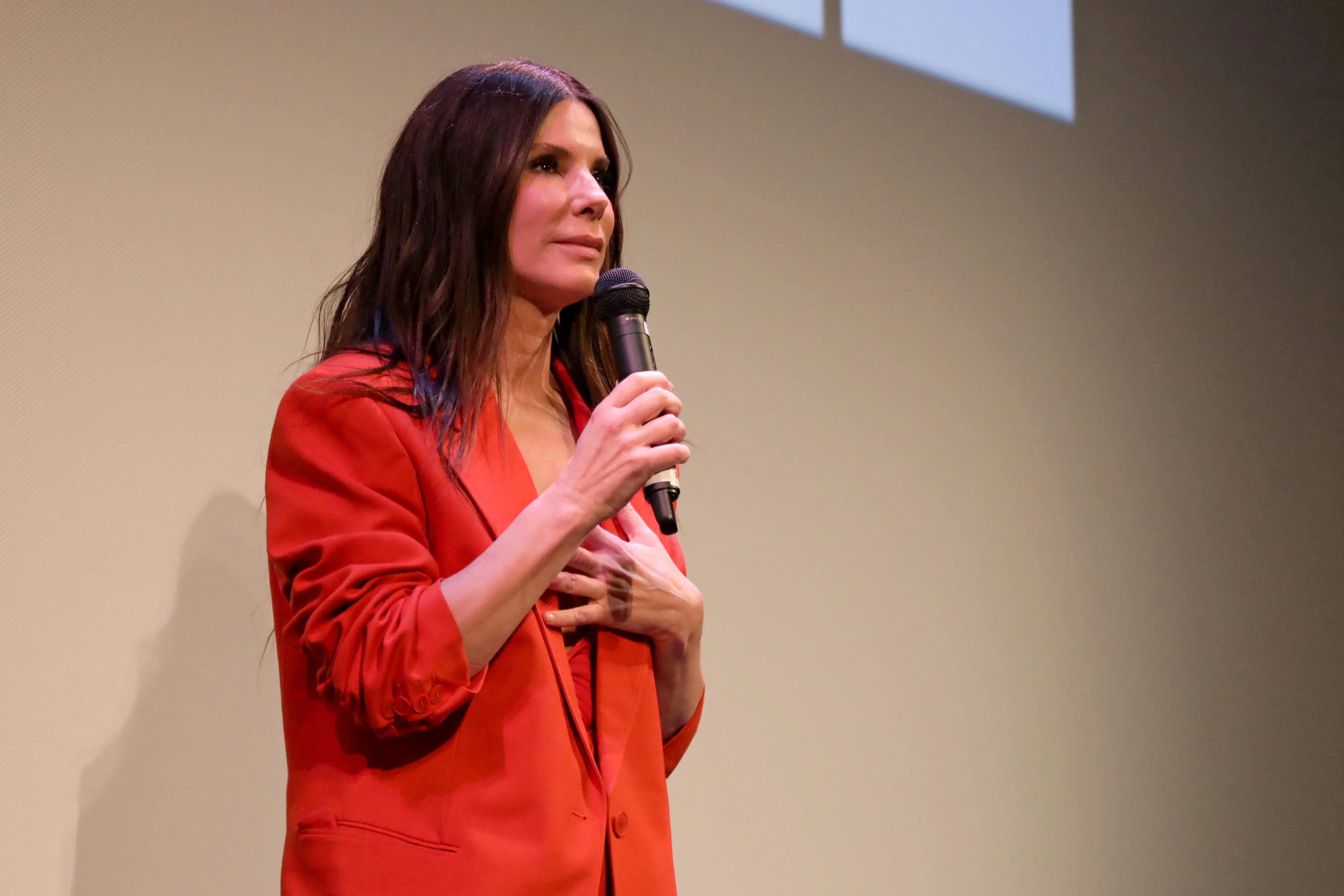 Sandra Bullock speaking into a microphone.