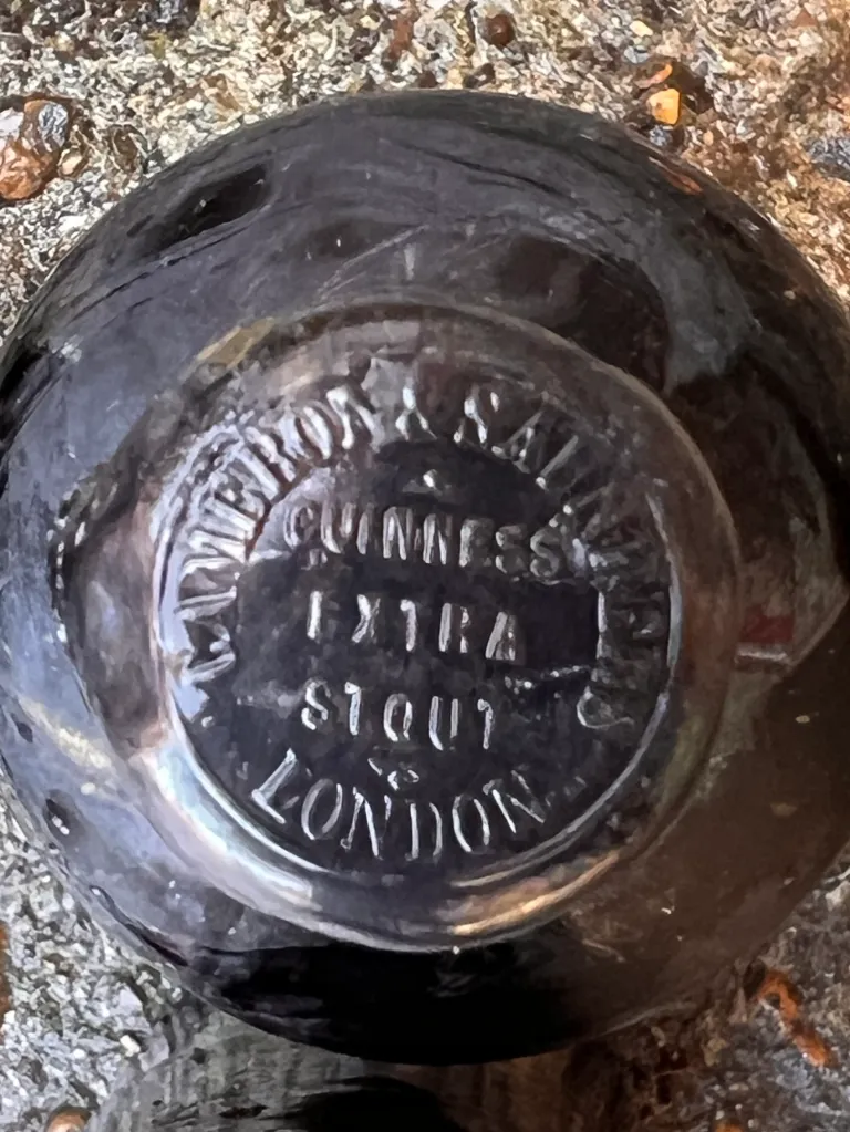 The bottom of a Guinness bottle, lost in a shipwreck over 160 years ago, showing the embossed text 