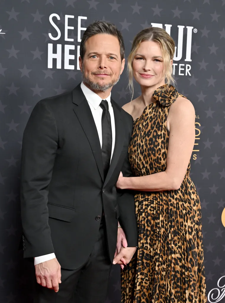 Scott Wolf and Kelley Wolf posing on the red carpet, holding hands.