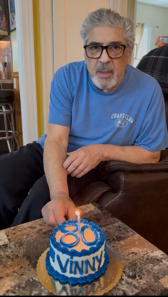 Man celebrating his 80th birthday with a cake that reads