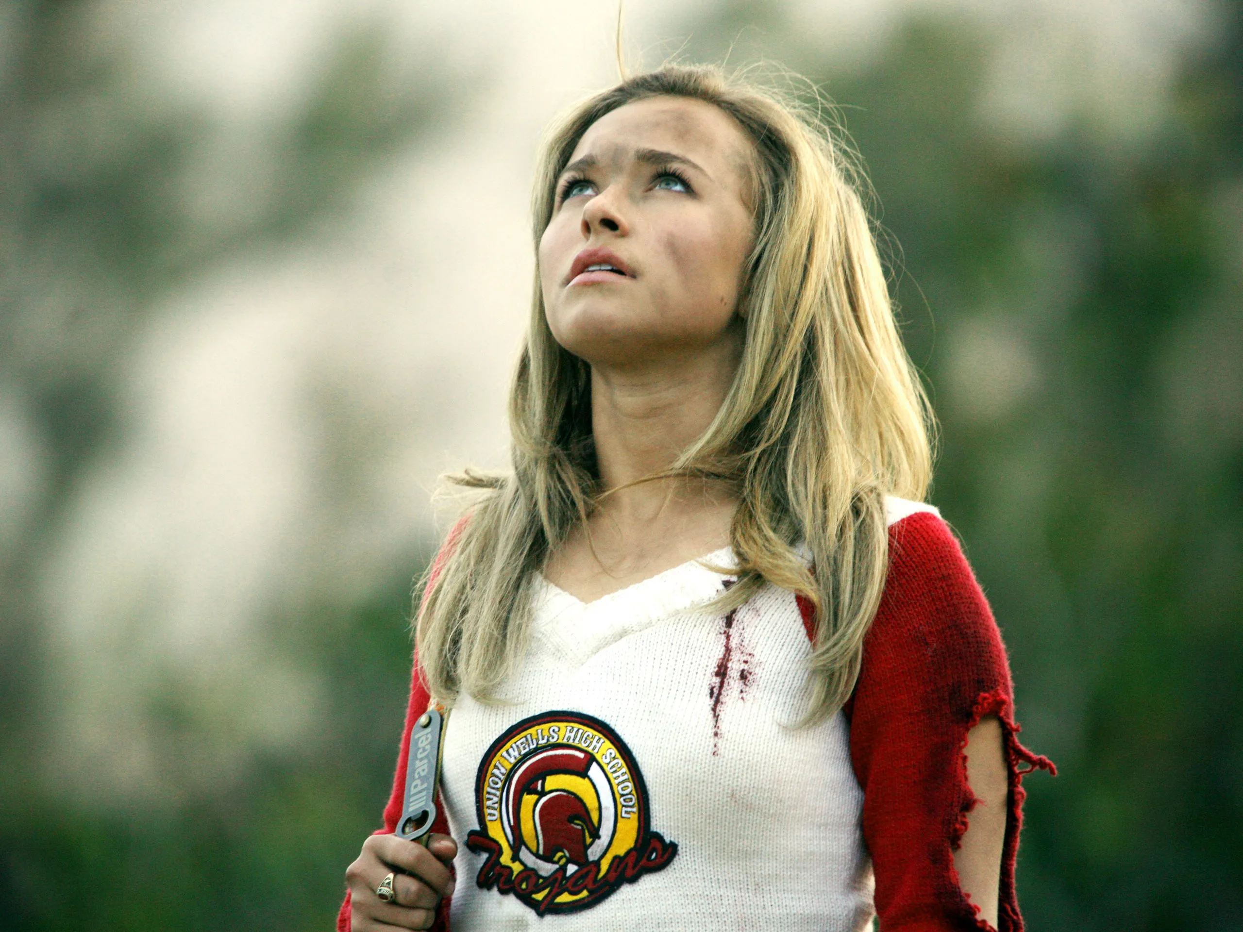 Hayden Panettiere looking up with a dirty face and bloodstains on her 