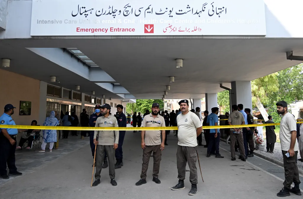 Security personnel stand guard at the Emergency Entrance of the Pakistan Institute of Medical Sciences (PIMS) Hospital after a fire.