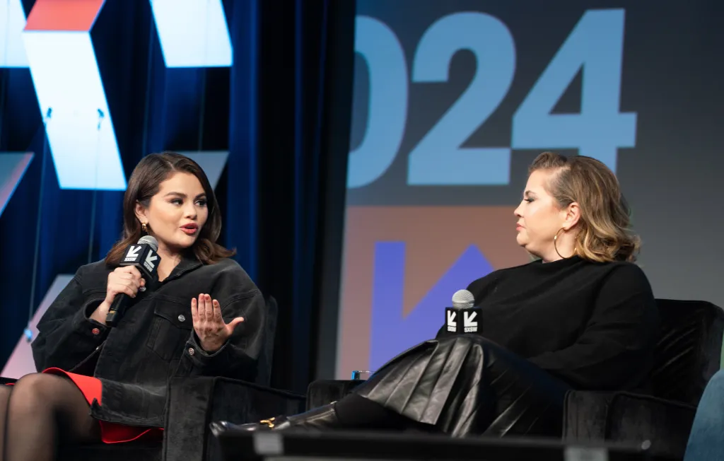 Selena Gomez and Mandy Teefey speaking at the 