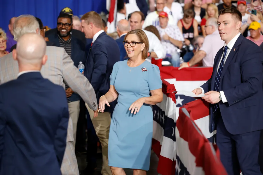 Sen. Darline Graham, R-S.C., in a light blue dress with an American flag pin, smiles as she arrives at her campaign event.