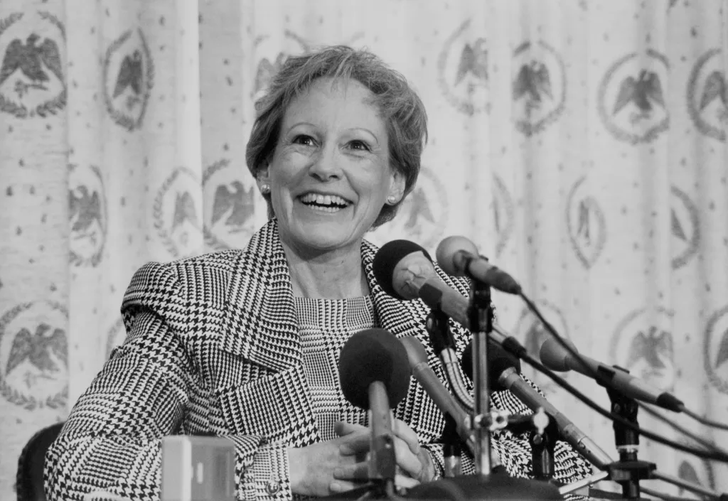 Sen. Nancy Landon Kassebaum Baker smiling at a press conference.