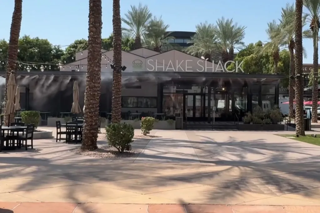 Shake Shack restaurant with outdoor seating and misters running.