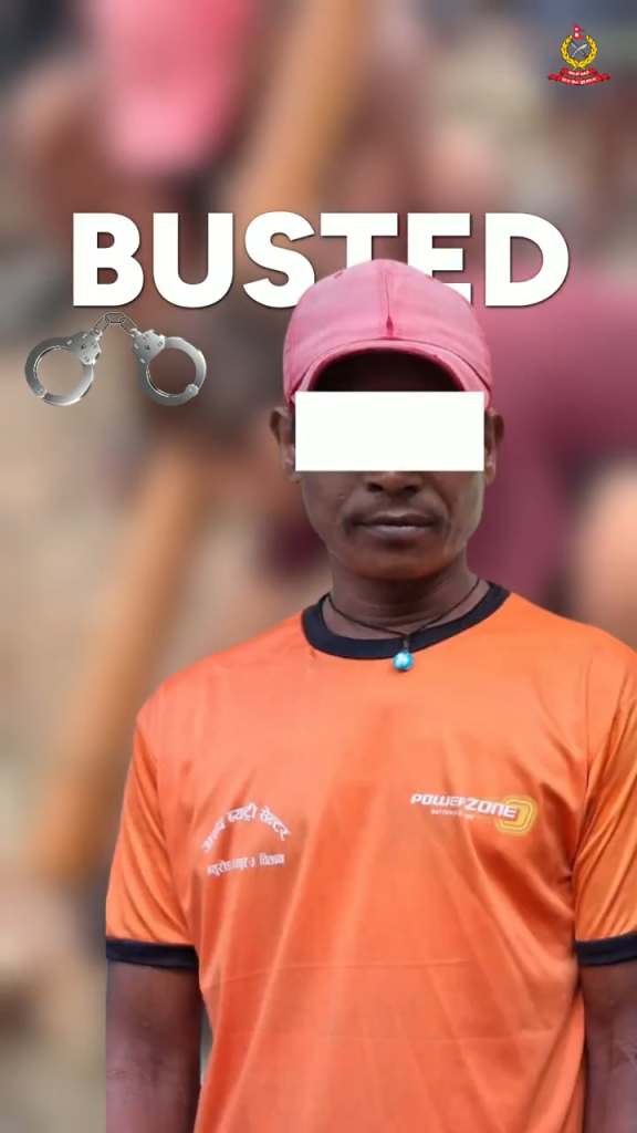 A man in an orange shirt and pink cap with a white rectangle over his eyes, with the word 