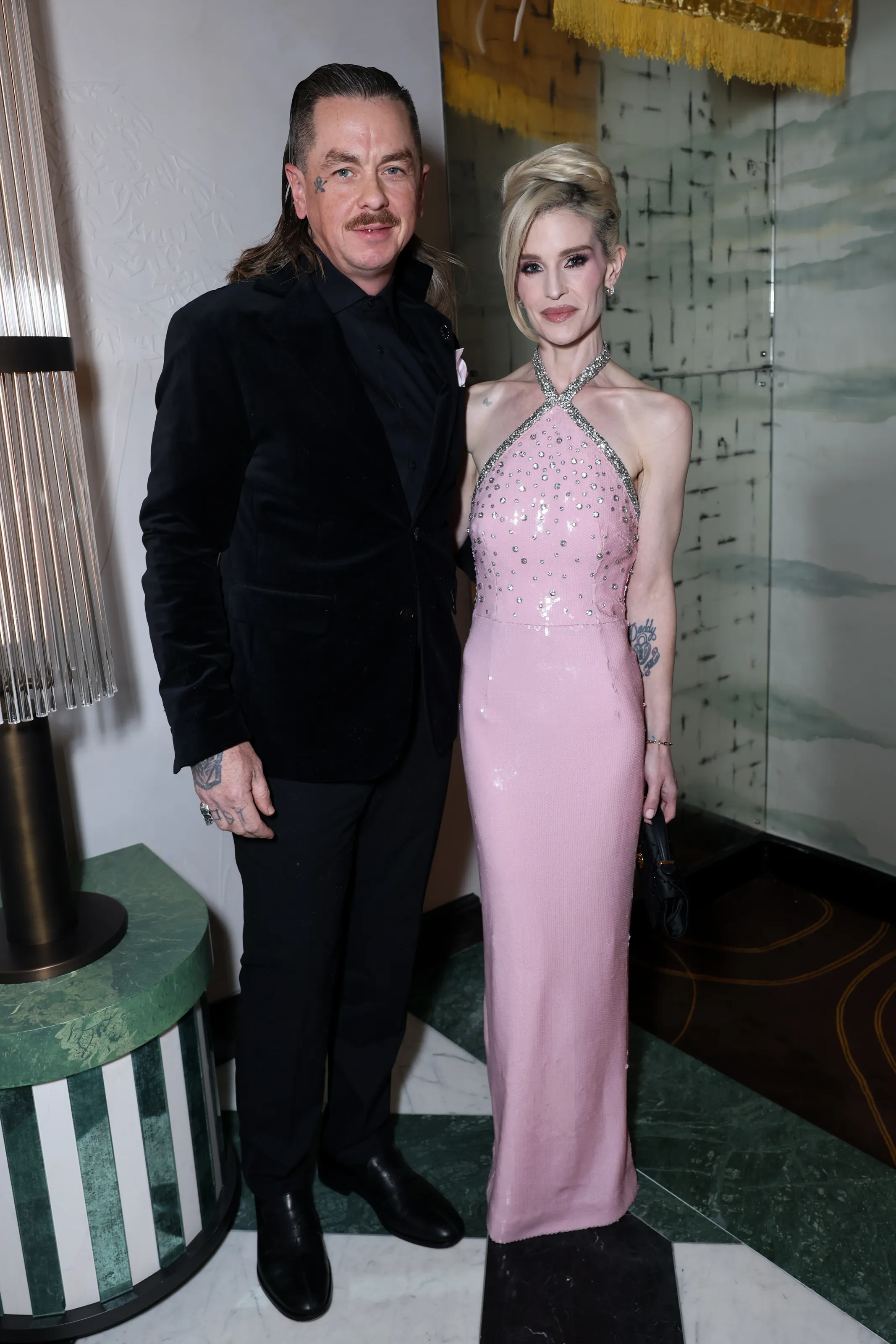 Sid Wilson and Kelly Osbourne posing for a photo.