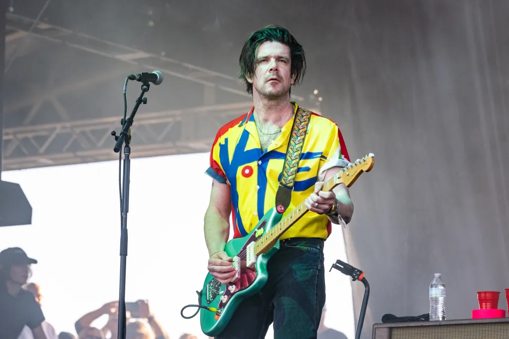 Simon O'Connor of Modest Mouse performing live on stage.