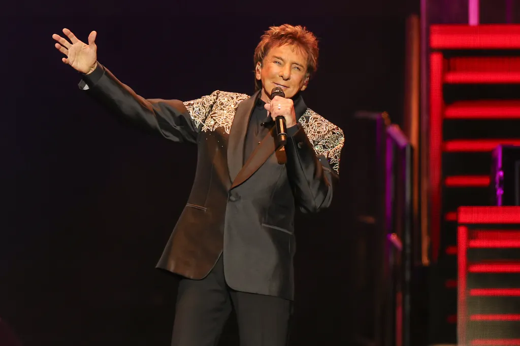 An image of Barry Manilow performing on stage