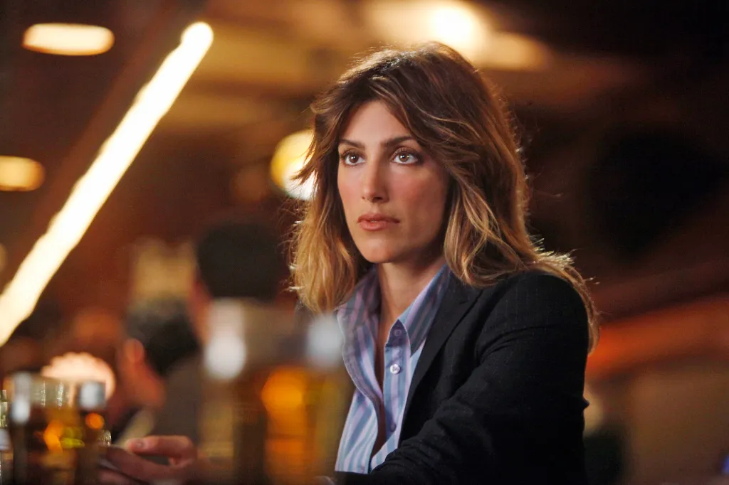 Jennifer Esposito as Jackie Curatola looking up and to the right.