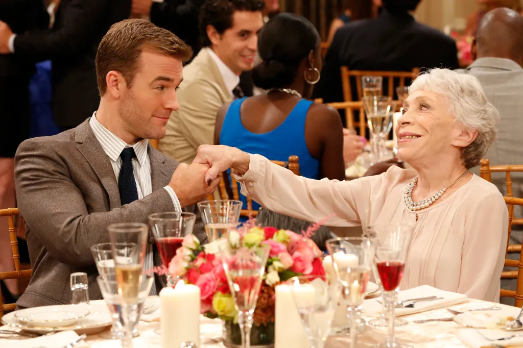 Will and Estelle Markowitz holding hands at a formal dinner.