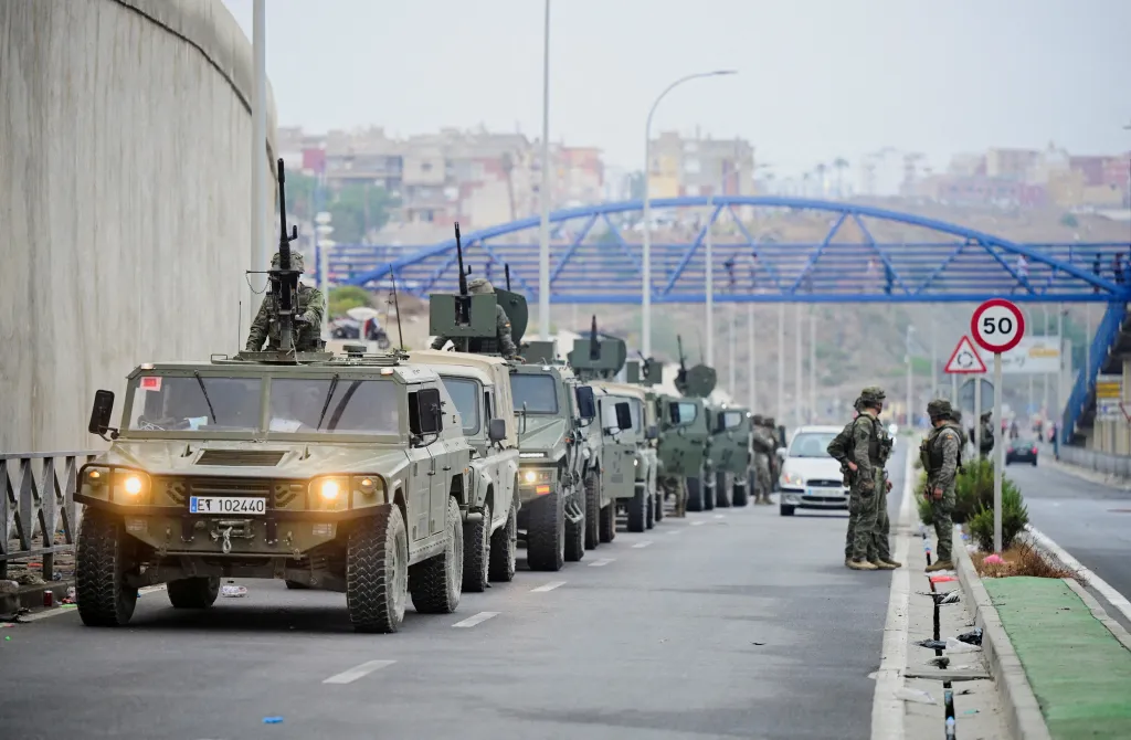 Spanish soldiers patrol in military vehicles near the Spanish-Moroccan border in Ceuta.