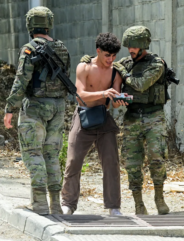 Spanish soldiers detain a migrant after a mass crossing on foot and by sea into Ceuta, on Aug. 1, 2026.