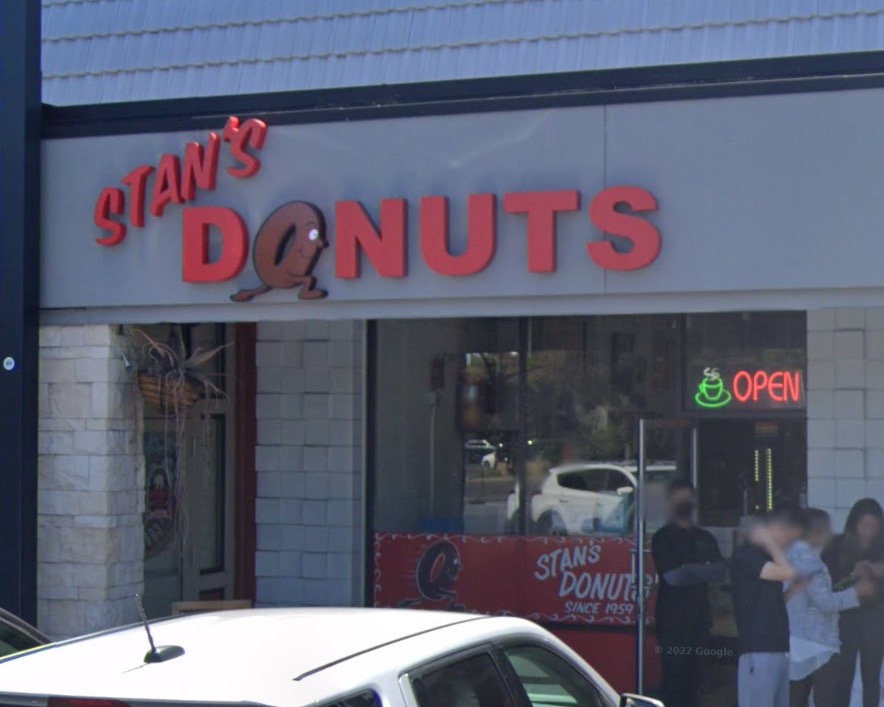 Exterior of Stan's Donuts at 2628 Homestead Rd, Santa Clara, CA 95051, showing its storefront with a red sign and a cartoon donut character.