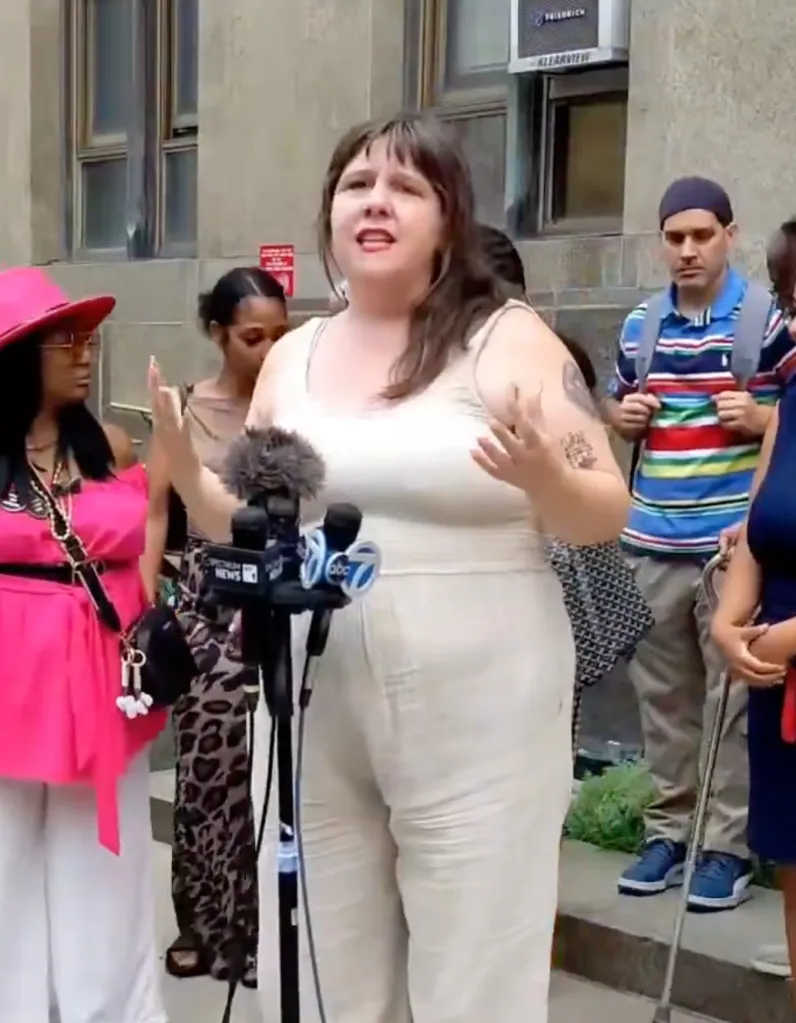 State Assemblywoman Emily Gallagher speaking to microphones at a news conference.