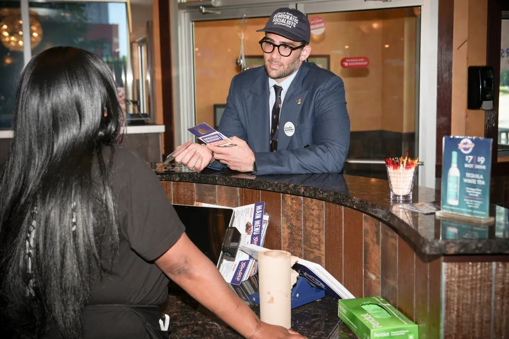 Hasan Piker canvassing for progressive candidates in a restaurant.