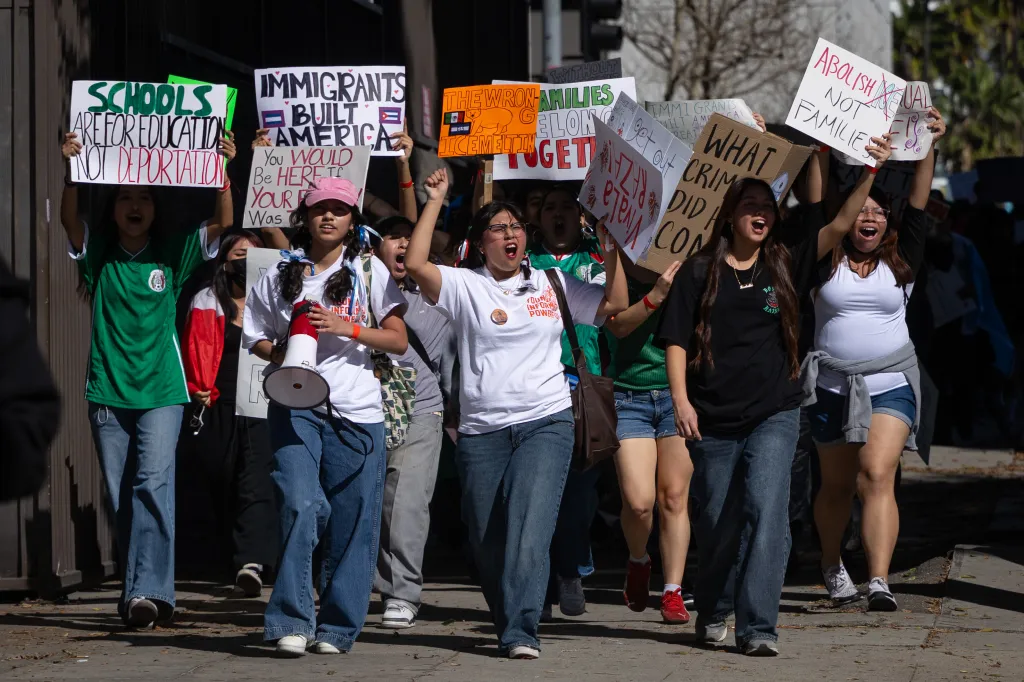 Students protest immigration crackdown, holding signs like